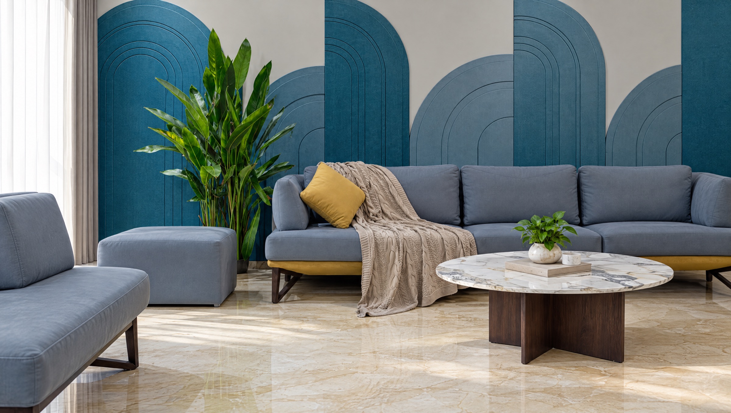 Lounge with arched wall panels in two shades of blue behind a grey sofa